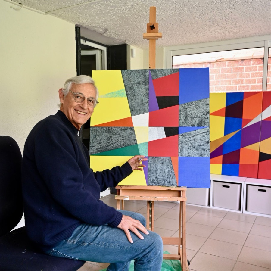 Pierre Calogero at his easel, in his studio.